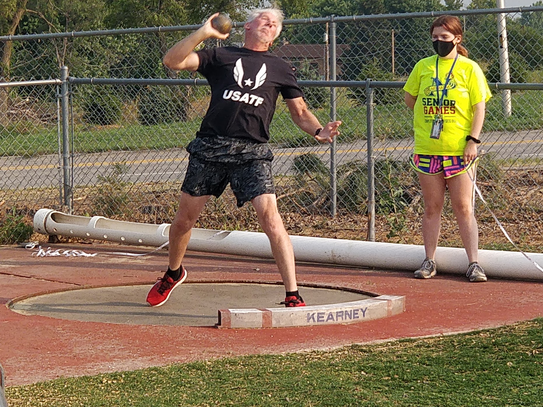 Club member throwing shot put